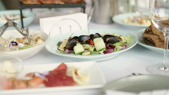 Catering service on banquet table with canape snacks in restaurant or hotel. Decorated food set on birthday, wedding celebration or business conference event venue.