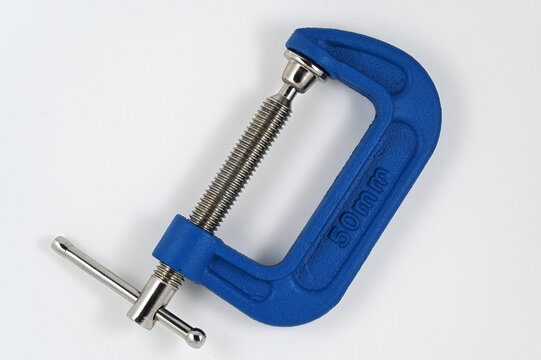 a blue metal C-clamp with a threaded steel screw