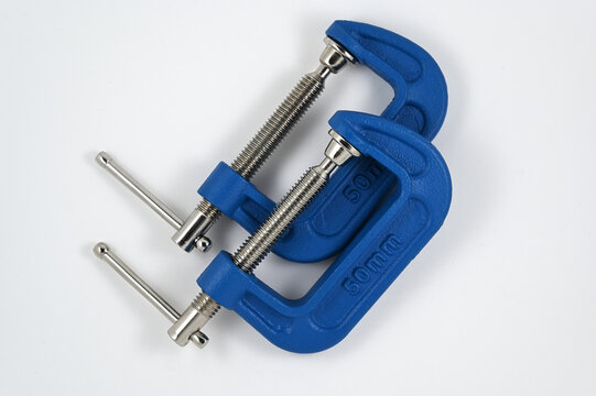 two blue metal C-clamps with threaded steel screws