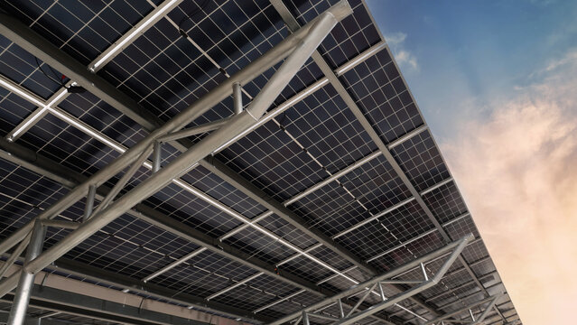 Solar panel car park roof. Low angle shot of Solar panel carport roof with steel structure generating clean renewable energy. Sustainable parking canopy with photovoltaic cells for eco power energy.