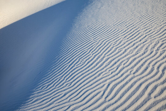 White Sands National Park, Alamogordo, view of a white sand slope with ridges and shadows.