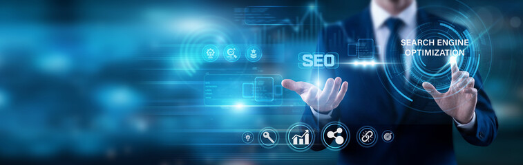Fototapeta premium Marketer pointing at SEO text. Improving the quality and quantity of website traffic by increasing the visibility of a web page to users of a web search engine through organic results.