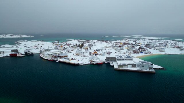 Frozen Sommaroya summer island covered in white snow in winter, aerial view