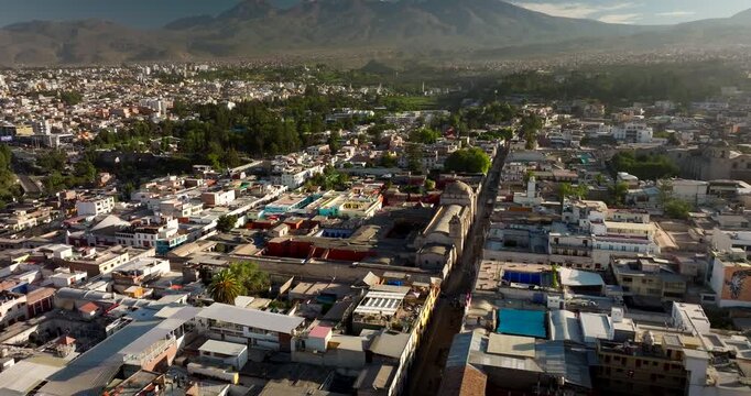Historic center of Arequipa, the white city, with Santa Catalina Monastery and Andes mountains in background. Aerial drone orbiting