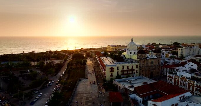 Santuario de San Cedro claver in Cartagena with sunset over ocean, aerial