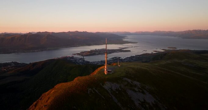 Telecommunication antenna atop Storheia mountain near Stokmarknes. Sunset drone
