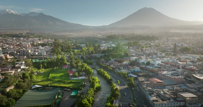 Arequipa, the white city, with Grau bridge over Chili river and isti volcano in background at sunrise. Aerial drone