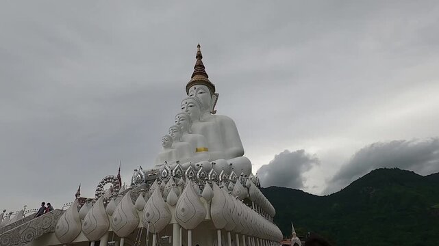 The majestic white Five Buddha statues at Wat Phra That Pha Sorn Kaew in Khao Kho, Thailand.