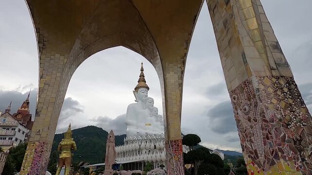 Five Buddha statues and colorful mosaic temple at Pha Sorn Kaew in Khao Kho, Thailand.