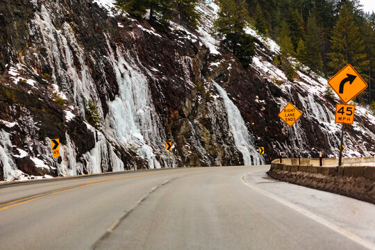 Winter on Highway 97 over Blewett Pass, cliffs and a sharp bend in the road.