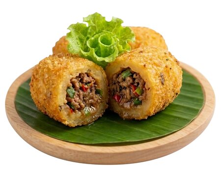 Indonesian Traditional Snack Combro, Deep Fried Cassava Fritters Stuffed with Spicy Fermented Soybean Oncom Paste on Banana Leaf