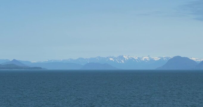 Beautiful and serene landscape with snow-capped mountains around Juneau. Alaska, during the summer.