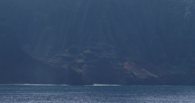 Napali Coast, Hawaii. Beautiful Landscape of the Napali coastline in a foggy morning,with emerald-hued cliffs with razor-sharp ridges towering above the Pacific Ocean.