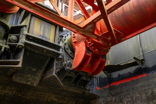 Industrial abstract- wide suction head with drag shoe and dual intake pipes on vintage river dredge in dry dock