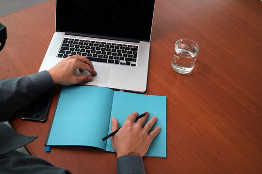 Businessman Working With Laptop And Notebook