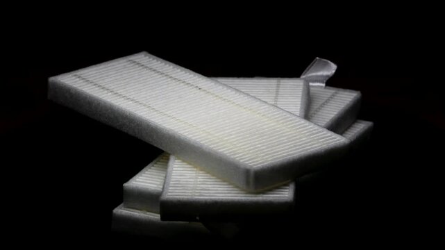 Robot Vacuum Cleaner Filters on Black Background With Dim Light &ndash; Smart Home Cleaning Accessories Video