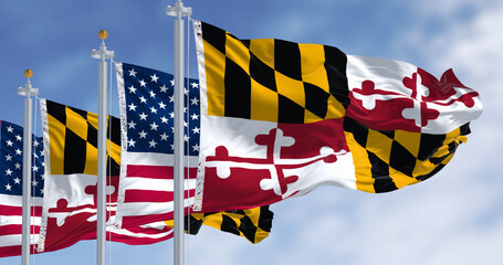 Obraz premium Maryland state flag waving with the american national flag on a clear day