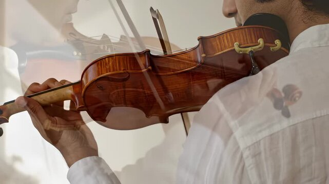 Person adjusts violin while focusing on fine-tuning instrument. Indoor setting features warm afternoon light. Concept of music education, instrument making, performance art