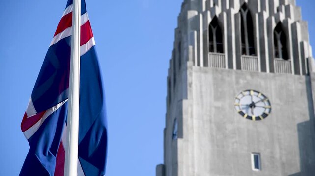 Iceland flag waving to the wind in front of Reykjavik Cathedral, Iceland
