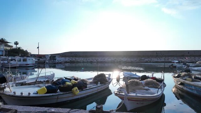 Backlit Fishing Boats with Nets Moored in Calm Harbor &ndash; Beautiful Lens Flare and Sun Reflection on Still Water, Lebanon