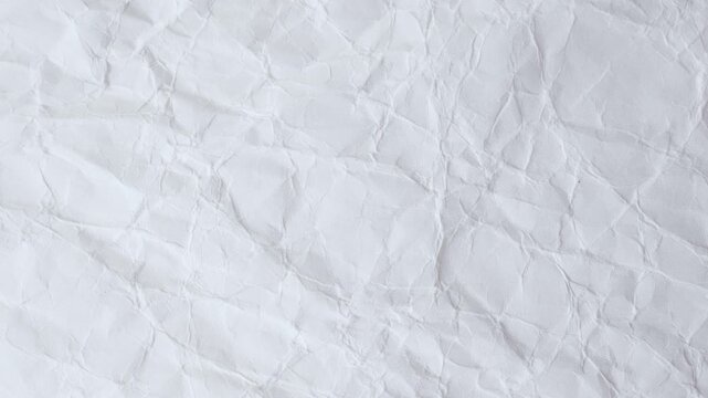 close up of hands squeeze and straighten the paper with copy space for text. crumpled paper background