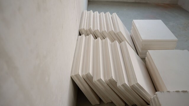 Drywall panels stacked against wall at construction site for interior finishing