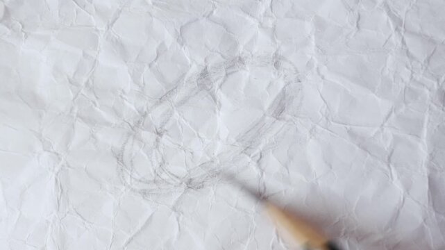close up of graphite pencil drawing on textured paper. slow motion footage. Background video can be used as overlay. doodling hatching