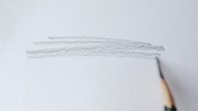 close up of graphite pencil drawing on textured paper. slow motion footage. Background video can be used as overlay. doodling hatching