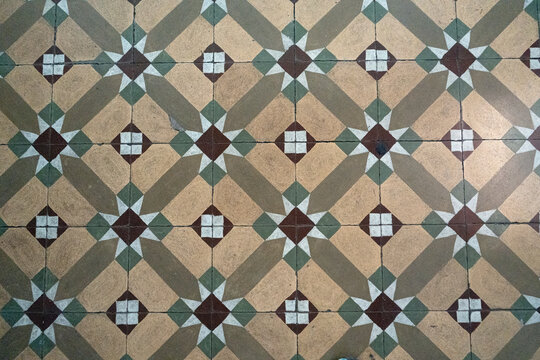 Neoclassical hydraulic mosaic floor with geometric star pattern and republican era ornamental tile design. 