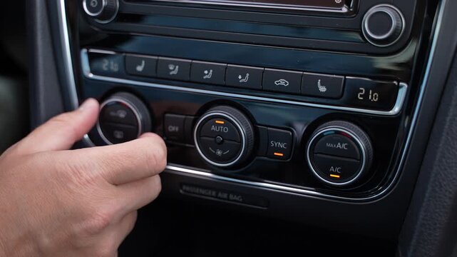 Adjusting Car Air Conditioning Controls Inside Modern Vehicle