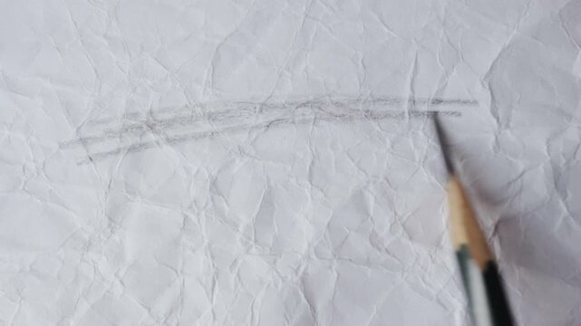 close up of graphite pencil drawing on textured paper. slow motion footage. Background video can be used as overlay. doodling hatching