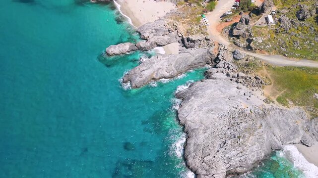 Aerial view of Klisidi rocks trident and tiny beaches, Crete. Drone flight from hidden coves to Damnoni Bay and high mountains. Scenic South Crete coastal landscape with turquoise sea water, 4k.