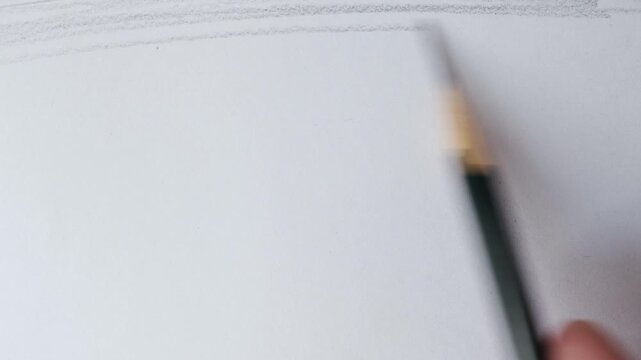 close up of graphite pencil drawing on textured paper. slow motion footage. Background video can be used as overlay. doodling hatching