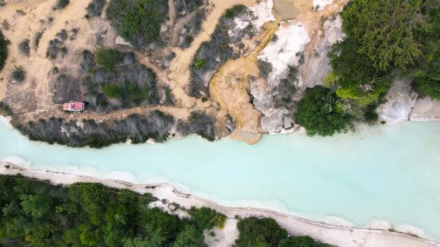 Bagno Vignoni natural pools along the city hill in Tuscany, view in spring season from drone