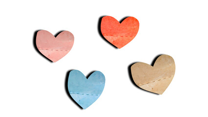 Obraz premium Four textured heart shapes in pastel colors floating elegantly on a clean white background.