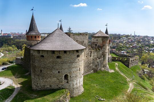 View of Kamianets-Podilskyi Castle featuring its massive stone towers with conical roofs and ancient defensive walls Kamianets'-podil's'kyi, Khmel'nyts'ka oblast, Ukraine.