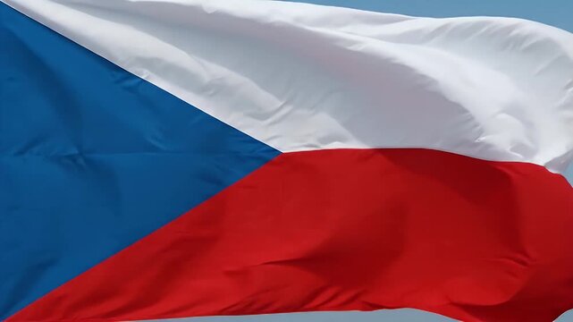 The video captures the vibrant flag of the Czech Republic gently waving in the breeze. The flag features a blue triangle along the hoist and horizontal bands of white and red.