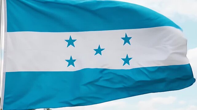The video features the national flag of Honduras waving gently in the breeze. The flag consists of three horizontal stripes; the middle stripe is white and contains five blue stars arranged in an X