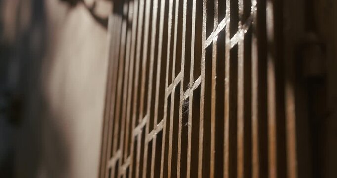 Close-up of a metal gate illuminated by sunlight with shallow depth of field in Zagreb, Croatia.