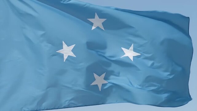 The video features the flag of the Federated States of Micronesia, showcasing a light blue field adorned with four white stars.