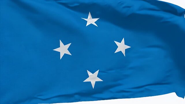 A close-up shot displays the national flag of Micronesia. The flag features a light blue field with four white, five-pointed stars in the center.