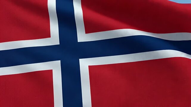 A close-up view of the Norwegian flag gently waving, showcasing its distinct red background with a dark blue Nordic cross outlined in white.
