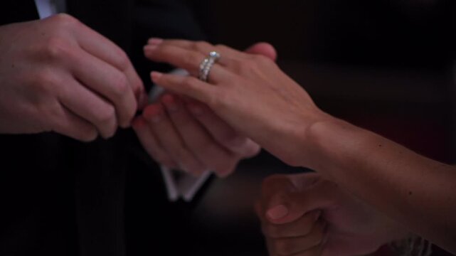 Slow motion video of him placing an engagement ring on his wife's finger.