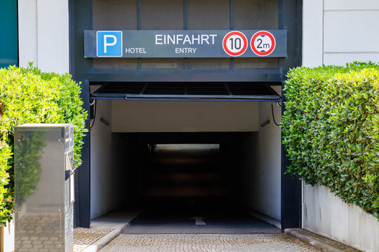 Parking entrance for hotel with height restriction sign at city location during daytime