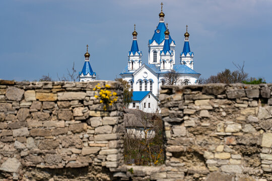 View of the white St. George's Cathedral with blue domes seen through the ancient stone walls of the fortress in Kamianets'-podil's'kyi, Khmel'nyts'ka oblast, Ukraine.