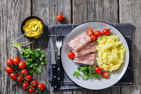 Slices of classic head cheese with mashed potatoes