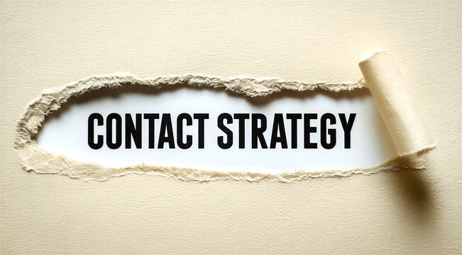 Torn paper revealing the words contact strategy for business planning and marketing concepts