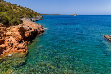 Fototapeta premium Crystal clear turquoise water and rocky coastline at Kolokitha, Crete, Greece