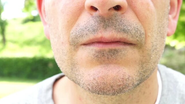 Close-up of a man's face performing the "hush" or silence sign, symbolizing hidden dangers or secret health risks.