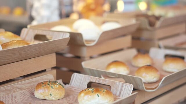 Freshly Baked Bread Rolls Displayed in Wooden Crates at a Bakery or Market Stall